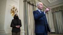President Joe Biden gestures while Vice President Kamala Harris stands behind him. (Shawn Thew/EPA/Bloomberg News)