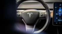 The steering wheel of a Tesla Inc. Model 3 electric vehicle