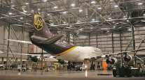 A plane undergoes maintenance inside a hangar at Louisville International Airport