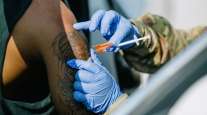 A man receives a vaccine shot at a drive-thru vaccination site in New Orleans,