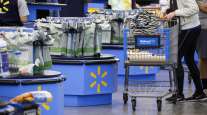 A customer pushes a shopping cart at a Walmart store in Burbank, Calif.