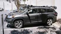A Zoox Inc. self-driving car sits parked outside the company's headquarters in Foster City, Calif.