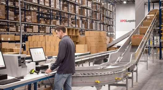An XPO Logistics employee works in a warehouse. (XPO Logistics)