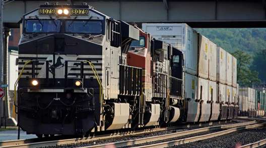 A Norfolk Southern freight train runs through a crossing in Homestead, Pa.