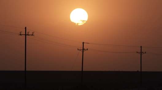  The sun rises over power lines near Imperial, Calif.