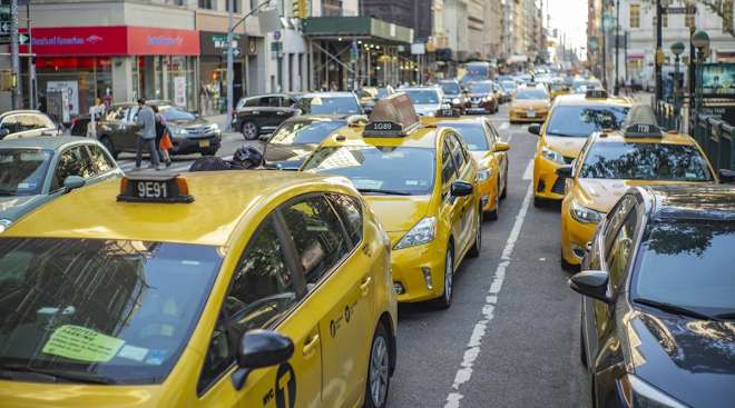 taxis and other cars on a New York City street
