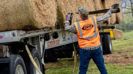 Alabama trucking volunteers load hay