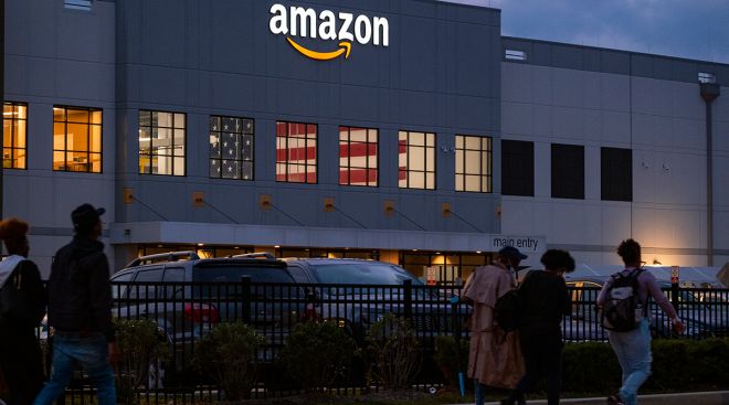 People arrive for work at an Amazon distribution center