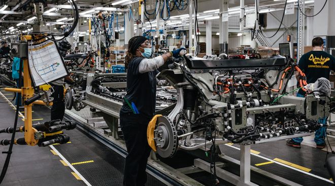 Workers assemble components of Rivian R1T electric pickup trucks