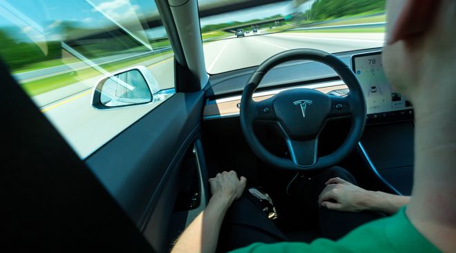 Inside of a Tesla displaying the company's self-driving technology