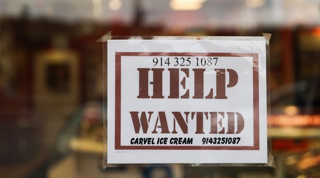 A store front Help Wanted sign