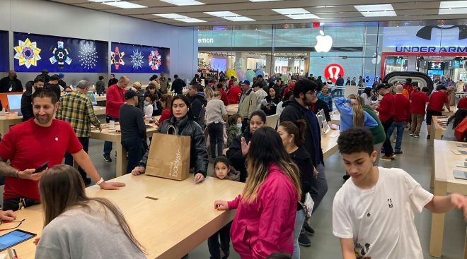 People shop at an Apple store