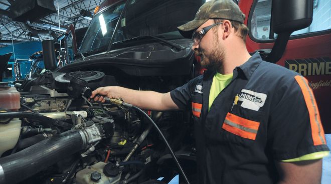 Prime technician adds oil to an engine