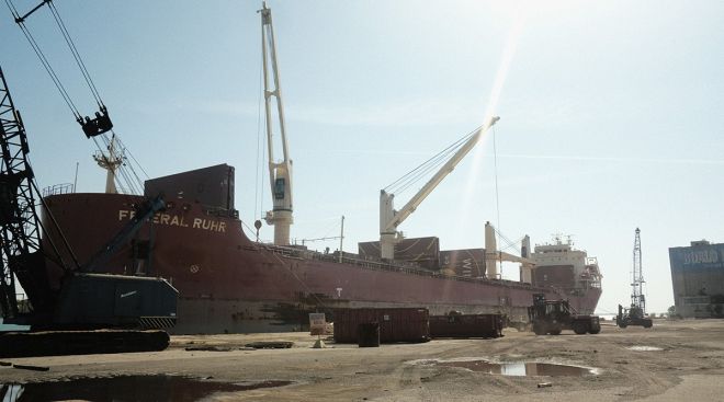 A freight ship is unloaded in the dockyard at the Port of Detroit