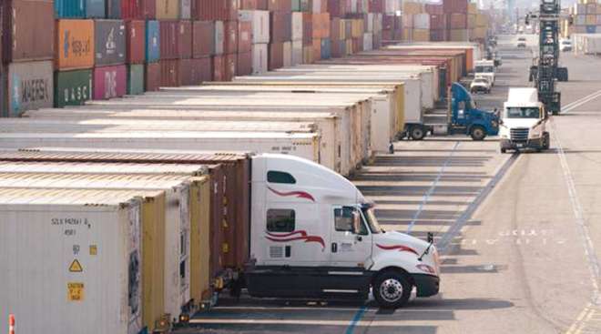 Trucks load and unload containers at Port of Long Beach