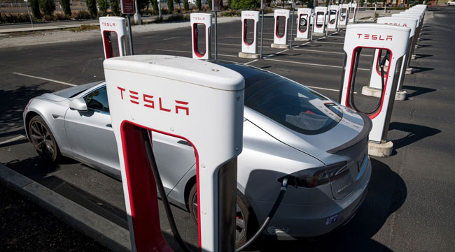 A Tesla vehicle charges at a Supercharger station in Petaluma, Calif., on Sept. 24.