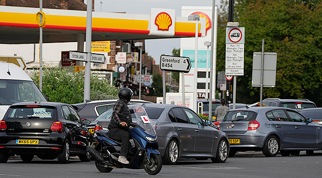 Drivers queue for fuel at a petrol station in London