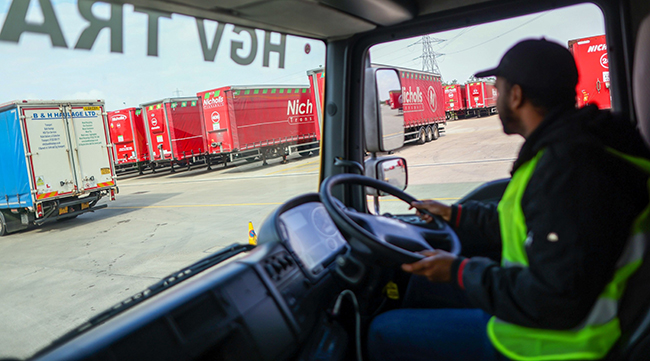 A trainee driver of a heavy goods vehicle performs a maneuver in a truck at Nicholls Transport