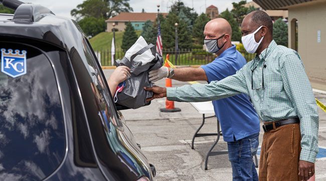 A motorist receives resources at a drive-thru job fair in Nebraska on July 15.