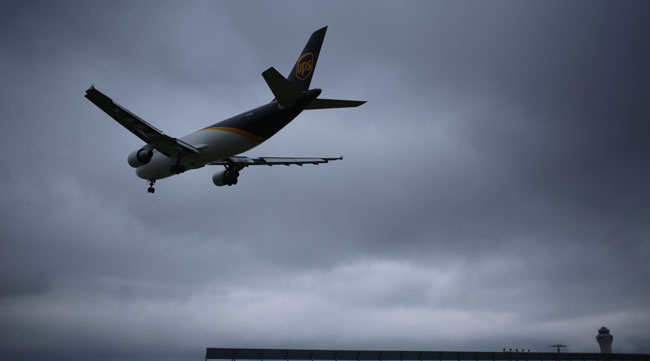A cargo jet descends for landing at the UPS Worldport facility in Louisville, Ky., on July 31.